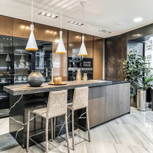 a kitchen with a bar and chairs